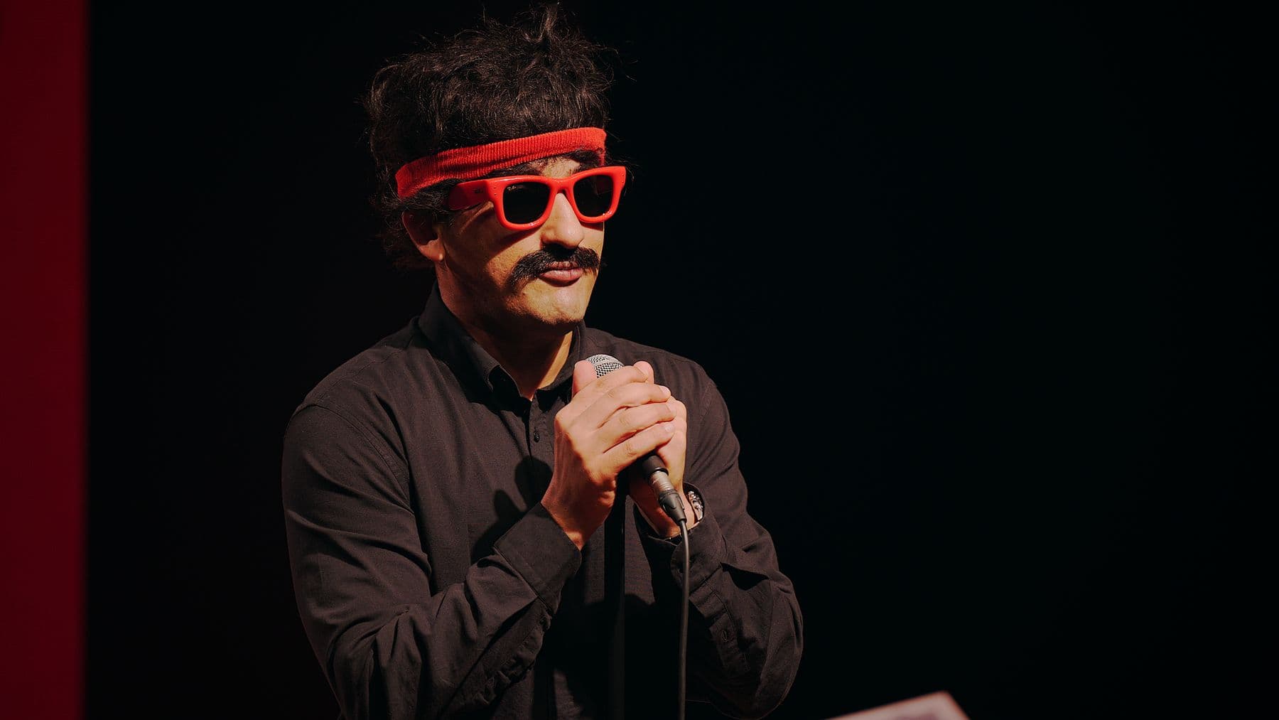 Mr. Nags holding the microphone on stage